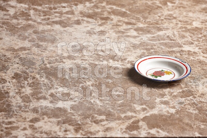 A vintage metal plate on beige marble background