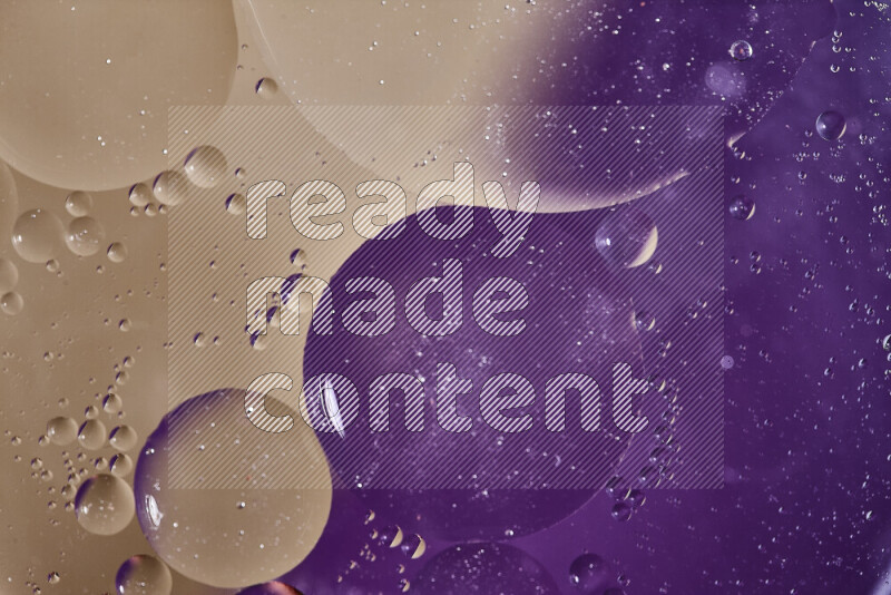Close-ups of abstract oil bubbles on water surface in shades of purple and brown