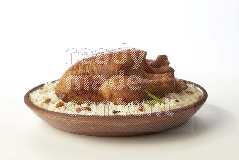 white  basmati Rice with  whole roasted chicken    on a pottery plate  direct  on white background