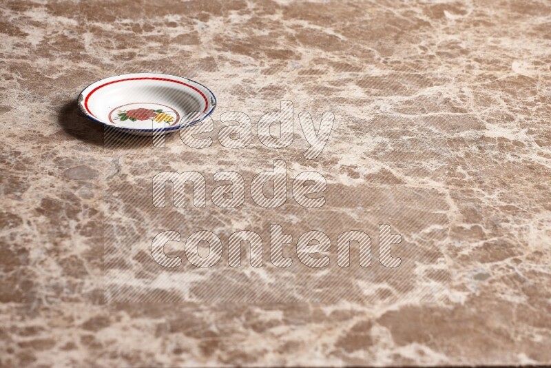A vintage metal plate on beige marble background