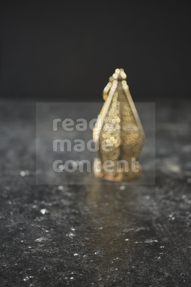 An out of focus lantern on textured black background