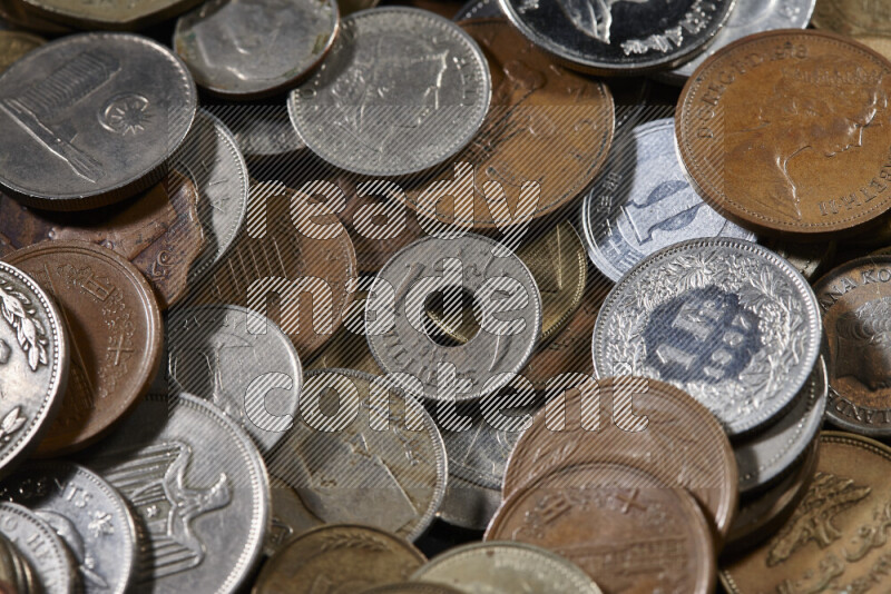 A close-ups of random old coins on black background