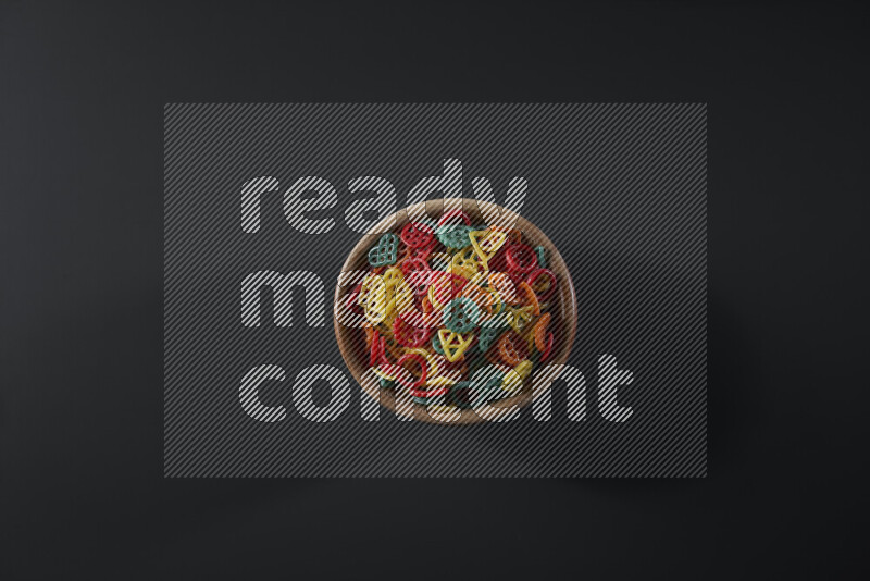 تسالي في وعاء خشبي على خلفية رمادية