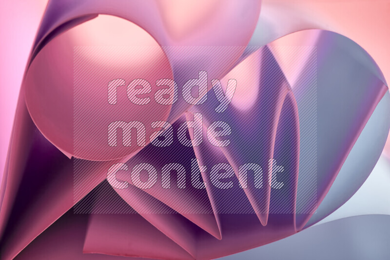 An artistic display of paper folds creating a harmonious blend of geometric shapes, highlighted by soft lighting in purple tones