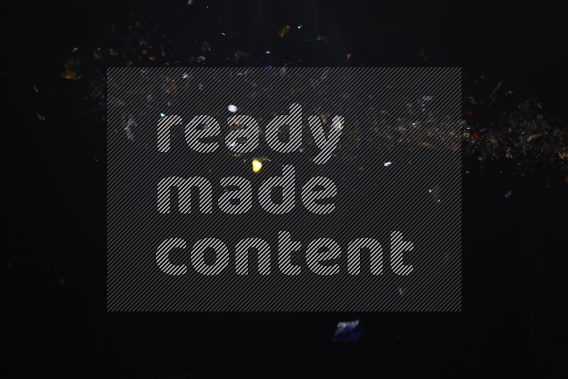 Falling multicolored confetti on black background
