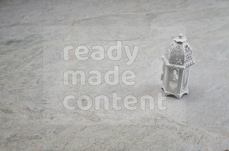 A candle lantern on grey marble background