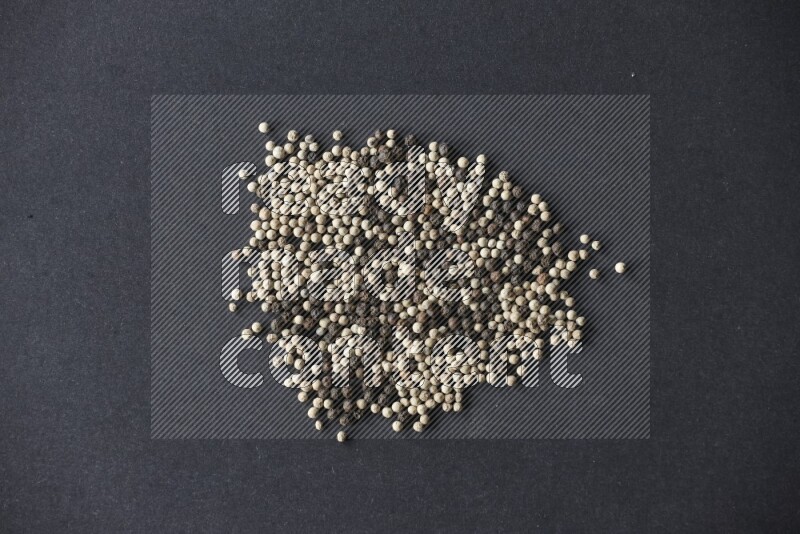 Mixed black and white pepper beads on a black flooring