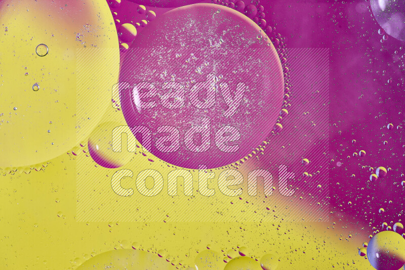 Close-ups of abstract oil bubbles on water surface in shades of yellow and pink