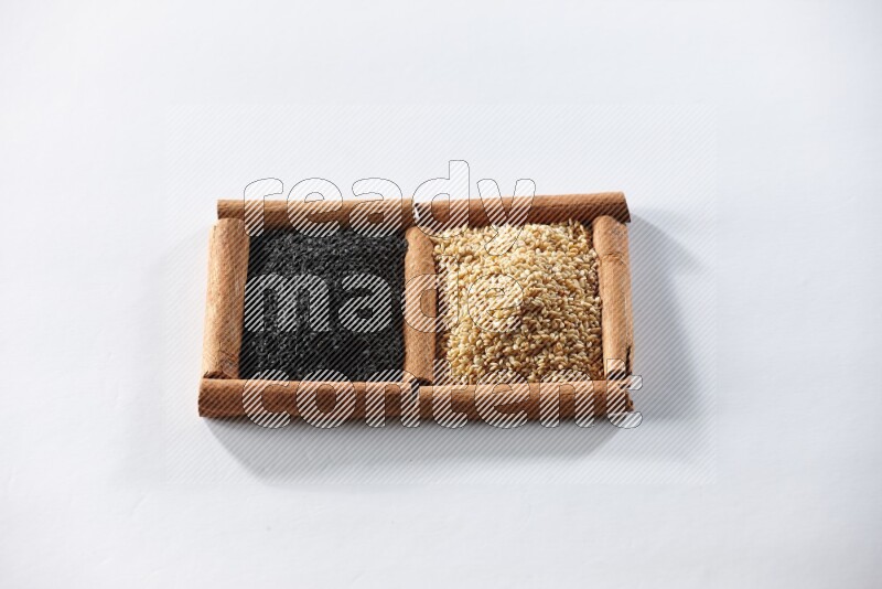 2 squares of cinnamon sticks full of sesame and black seeds on white flooring