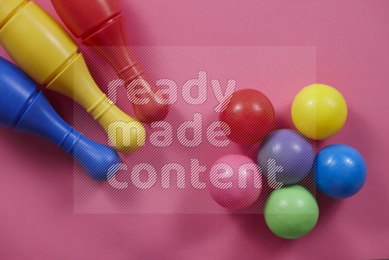 أوتاد البولينج البلاستيكية مع الكرات علي خلفيات ملونة مختلفة (ألعاب أطفال)