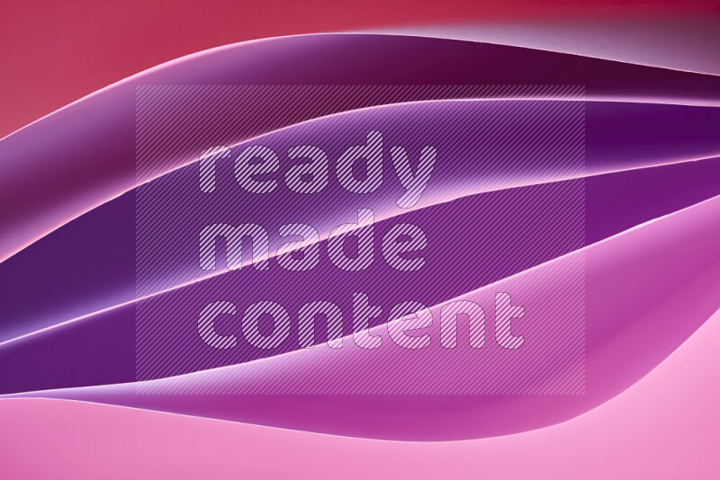 هذه الصورة تعرض تكوين فن الورق التجريدي مع منحنيات ورقية بتدرجات لونية دافئة مختلفة المكونه بواسطة الضوء الملون