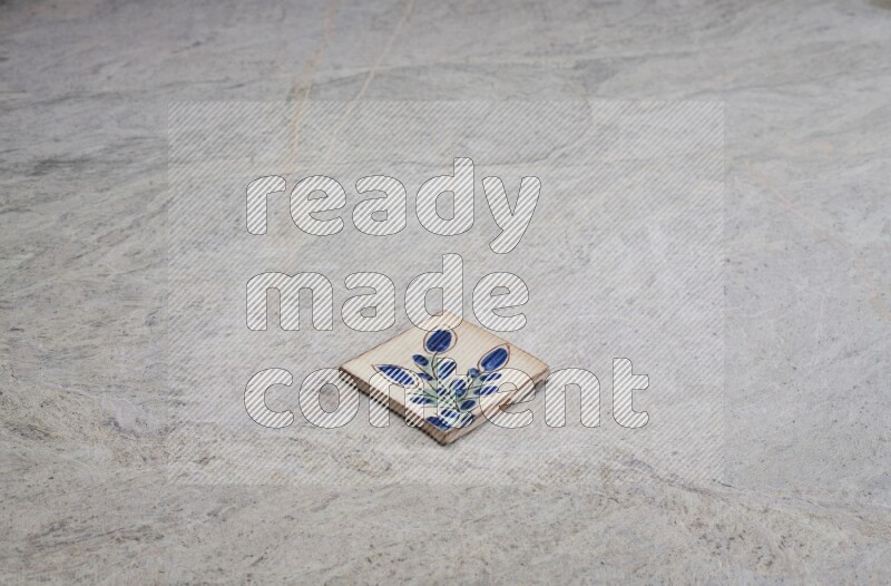 Top view shot of a pottery coaster\ tile on beige marble flooring