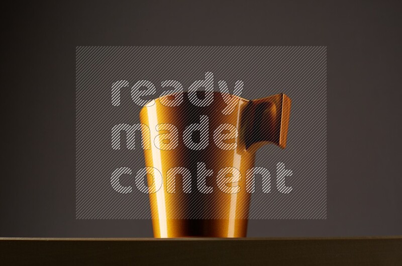 Low angle shot of a golden cup on grey background