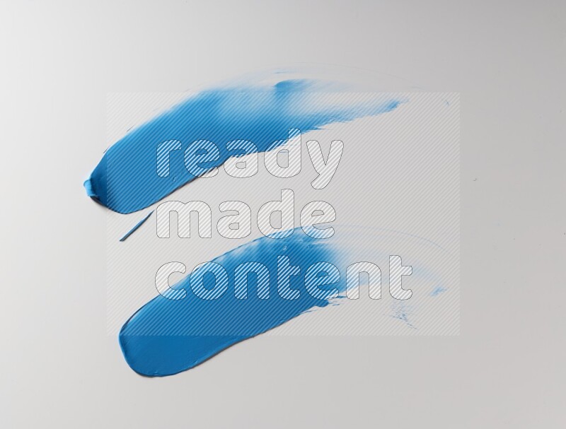 Blue curved painting knife strokes on white background