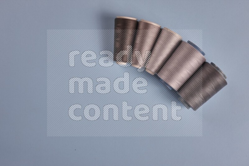 مجموعة من أدوات الخياطة والتفصيل رمادية اللون على خلفية زرقاء