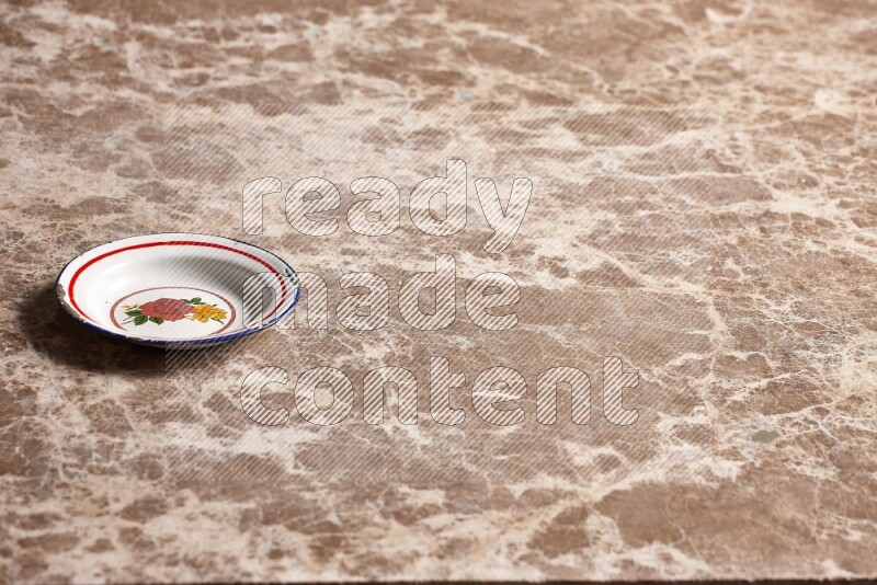 A vintage metal plate on beige marble background
