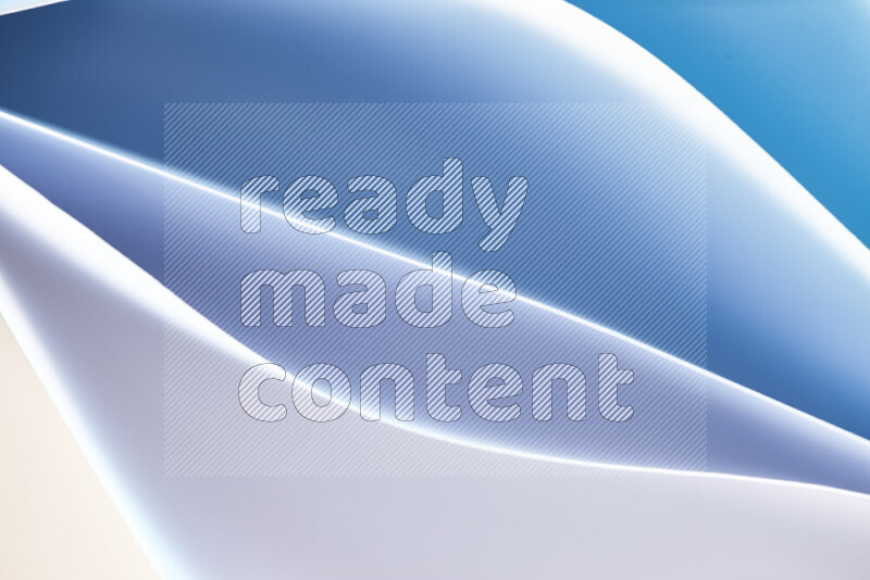 This image showcases an abstract paper art composition with paper curves in blue and white gradients created by colored light