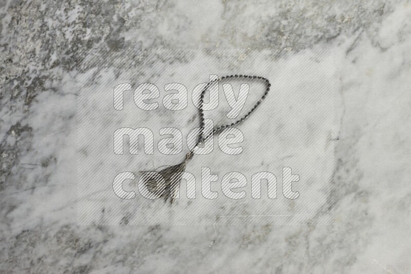 A prayer beads placed on grey marble background