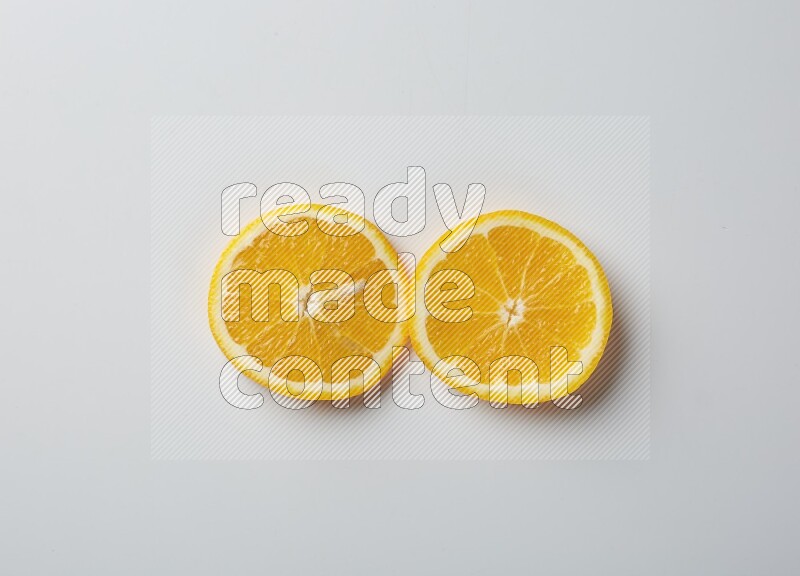 Two orange slices on white background