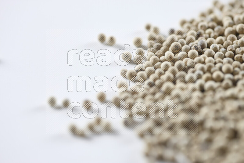 White pepper beads on white background