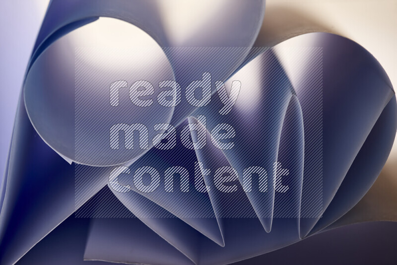 An artistic display of paper folds creating a harmonious blend of geometric shapes, highlighted by soft lighting in blue tones