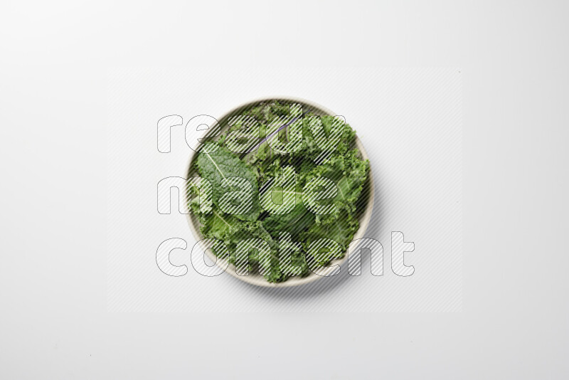 A bowl of fresh vegetables salad with kale leaves, cherry tomatoes, sliced radishes and sliced cucumber on a white background