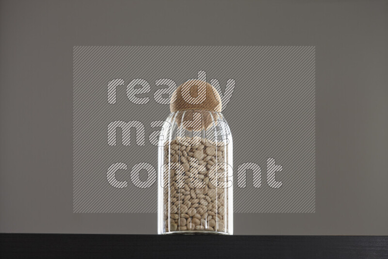 Lupin Beans in a glass jar on black background
