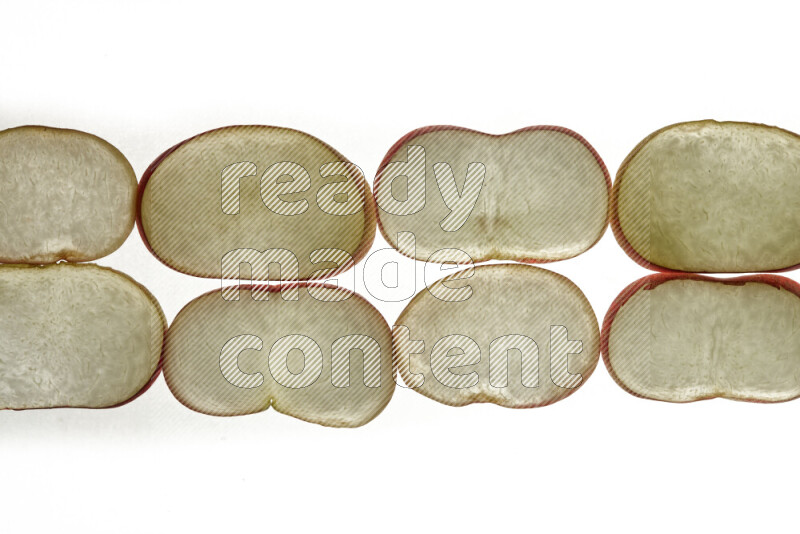 Peach slices on illuminated white background