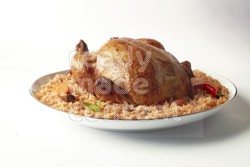 red basmati Rice with whole roasted chicken on a white plate with a silver rim direct on white background
