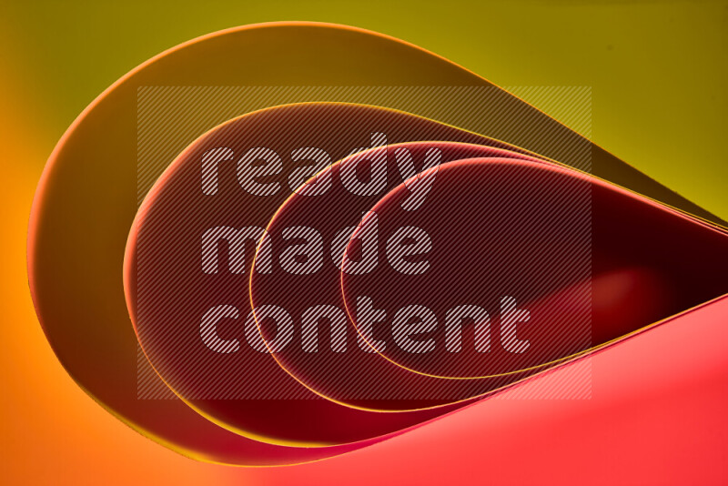 An abstract art of paper folded into smooth curves in yellow, brown and red gradients