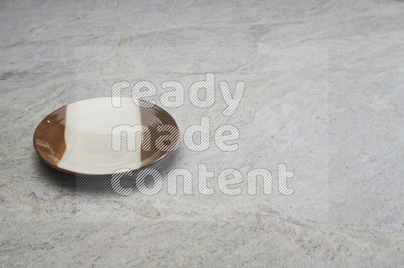 Multicolored Pottery Plate On Grey Marble Flooring