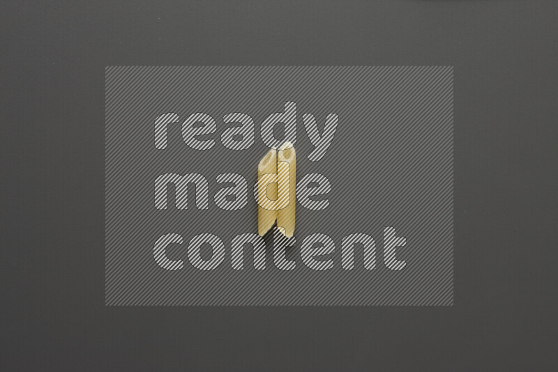 Mini penne pasta on grey background