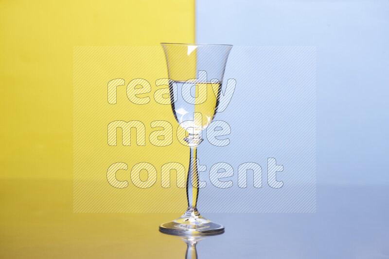 The image features a clear glassware filled with water, set against yellow and light blue background