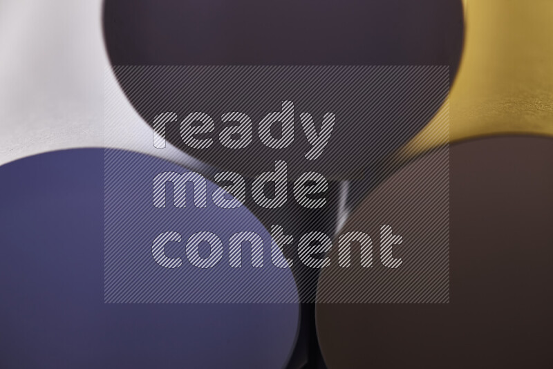 The image shows an abstract paper art with circular shapes in varying shades of grey and warm tones