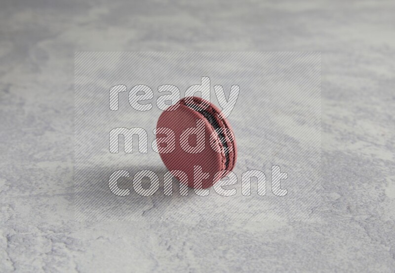 45º Shot of Red Cherry macaron on white  marble background