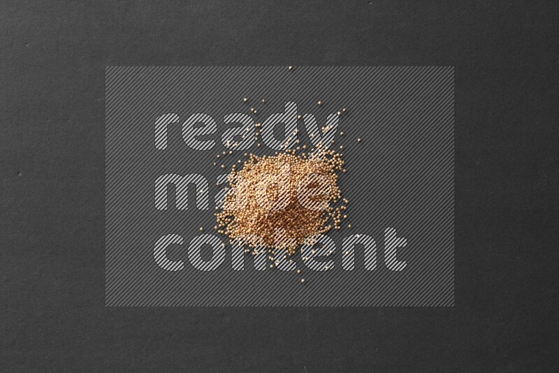 Mustard seeds on a black flooring