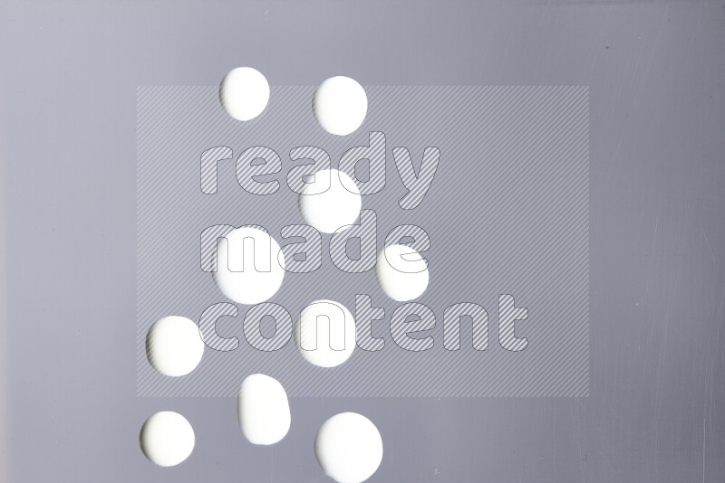 Close-ups of abstract white paint droplets on the surface