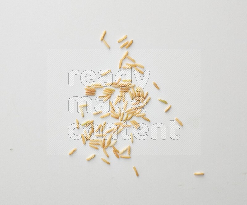 Top-view shot of long grain brown rice on white background