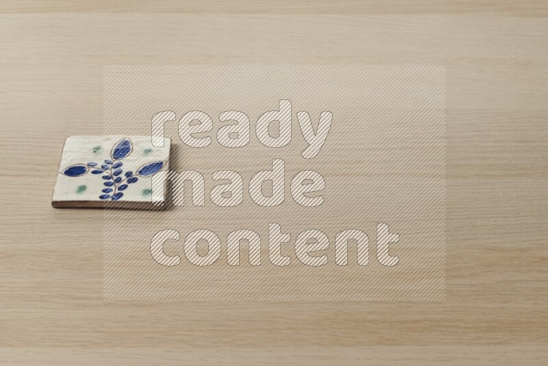 A decorative coaster on light wooden background