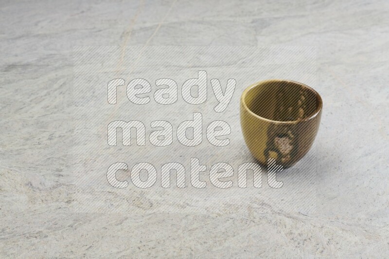 A multicolored pottery Cup on grey marble background