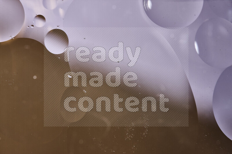 Close-ups of abstract oil bubbles on water surface in shades of white and brown