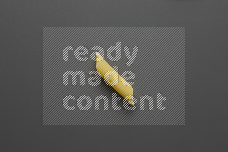 Penne pasta on grey background