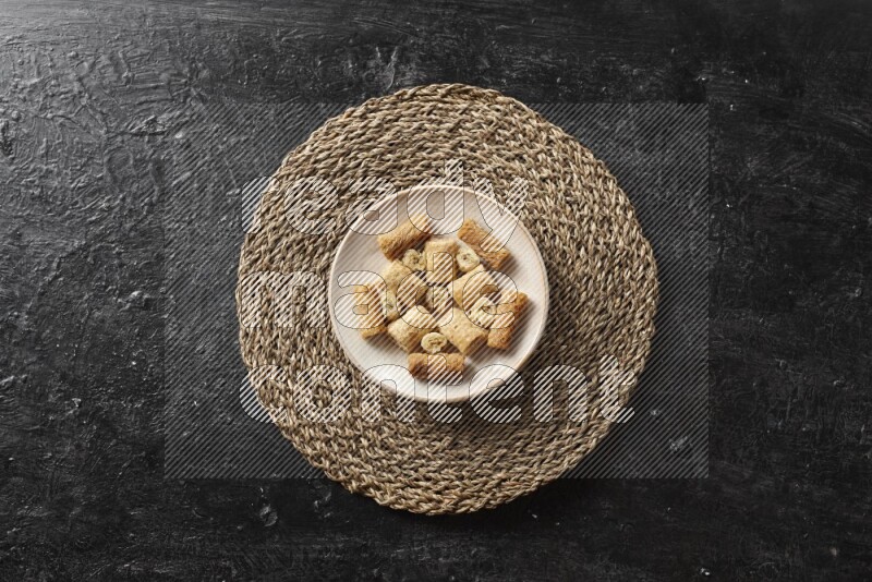 Oriental sweets in pottery plates in a dark setup
