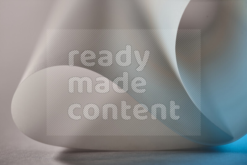 An abstract art piece displaying smooth curves in blue and grey gradients created by colored light