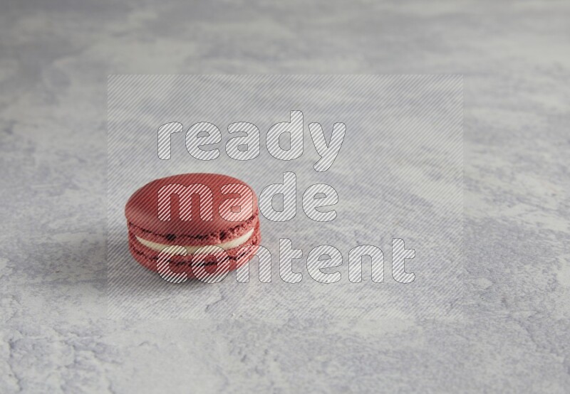 45º Shot of Red Velvet macaron on white  marble background