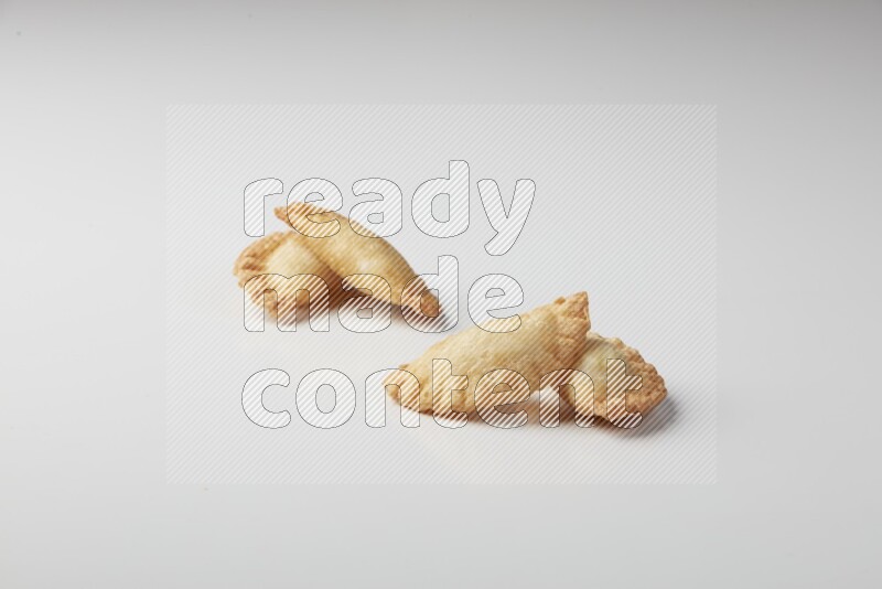 Four fried sambosas on a white background