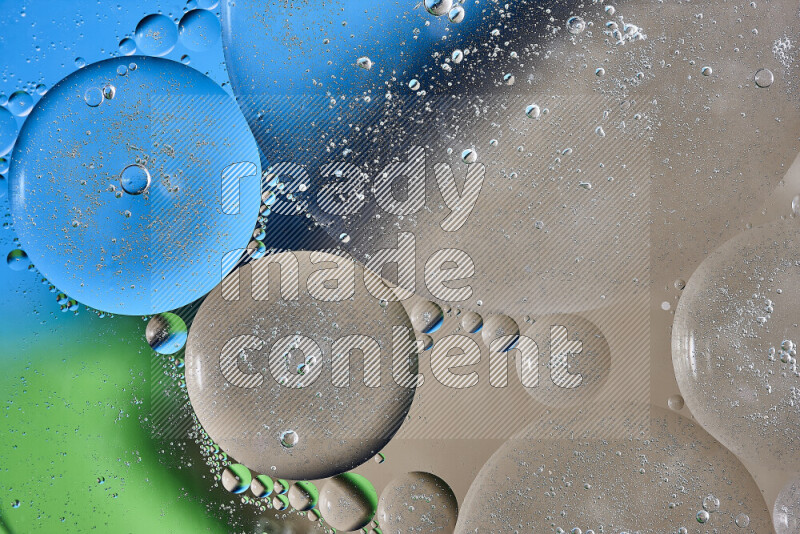 Close-ups of abstract oil bubbles on water surface in shades of brown, green and blue