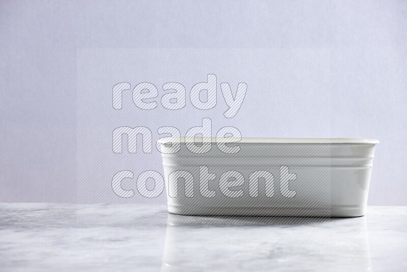 An empty white plant pot on grey marble background
