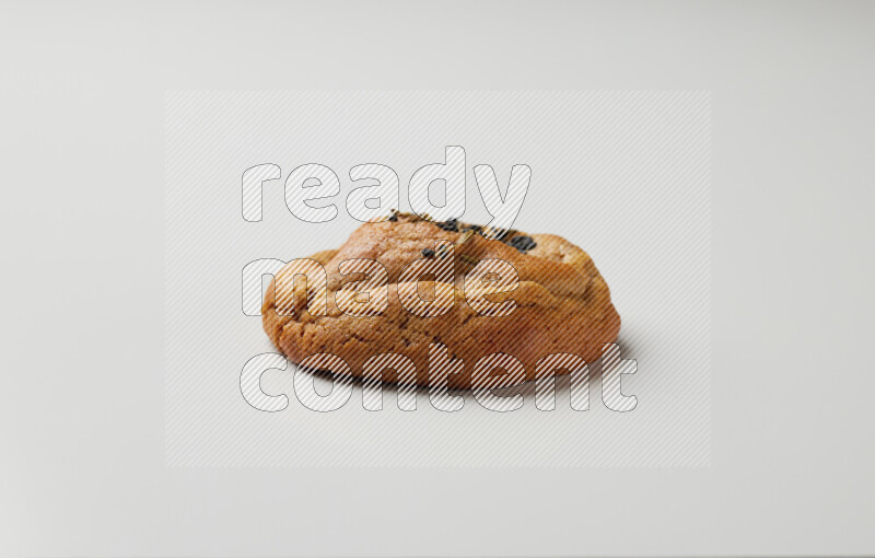 Hasawi cookie field with date and decorated by black seed and Anise grain on a white background