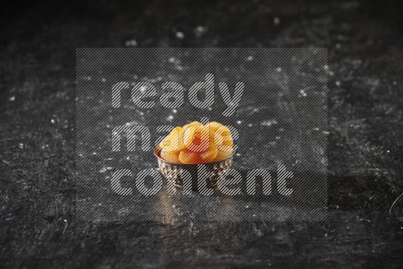 فواكه مجففة في وعاء معدني علي خلفية سوداء